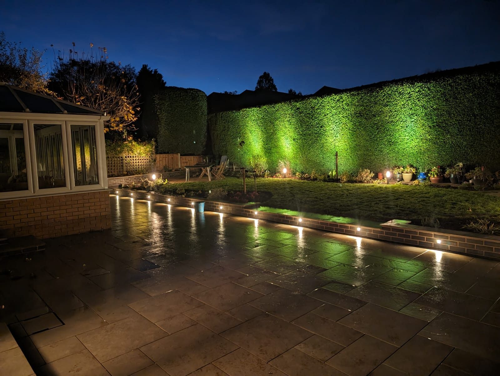 Garden electrical services in Nottingham: recessed patio lights and hedge uplighting at night