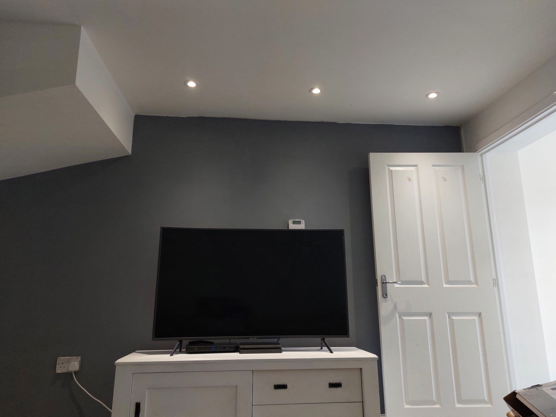 Living room with recessed downlights fitted in a bulkhead ceiling during a renovation