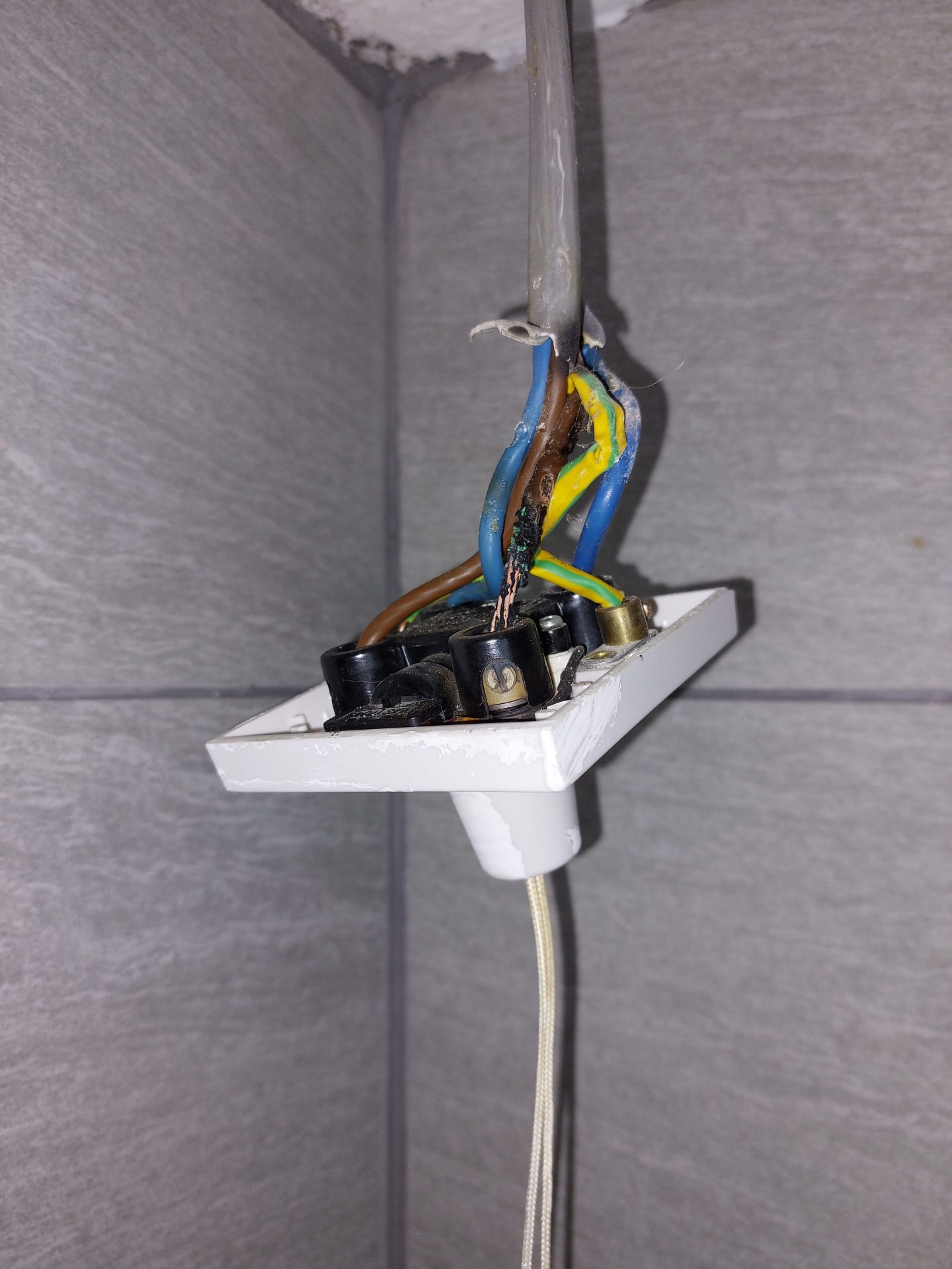 Loose and damaged wiring found behind a socket during fault finding