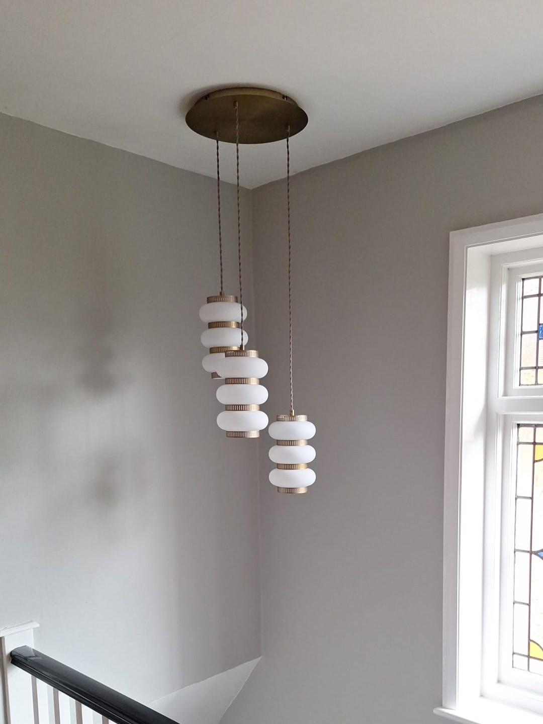 Cluster pendant light fitted over a stairwell as part of a lighting upgrade