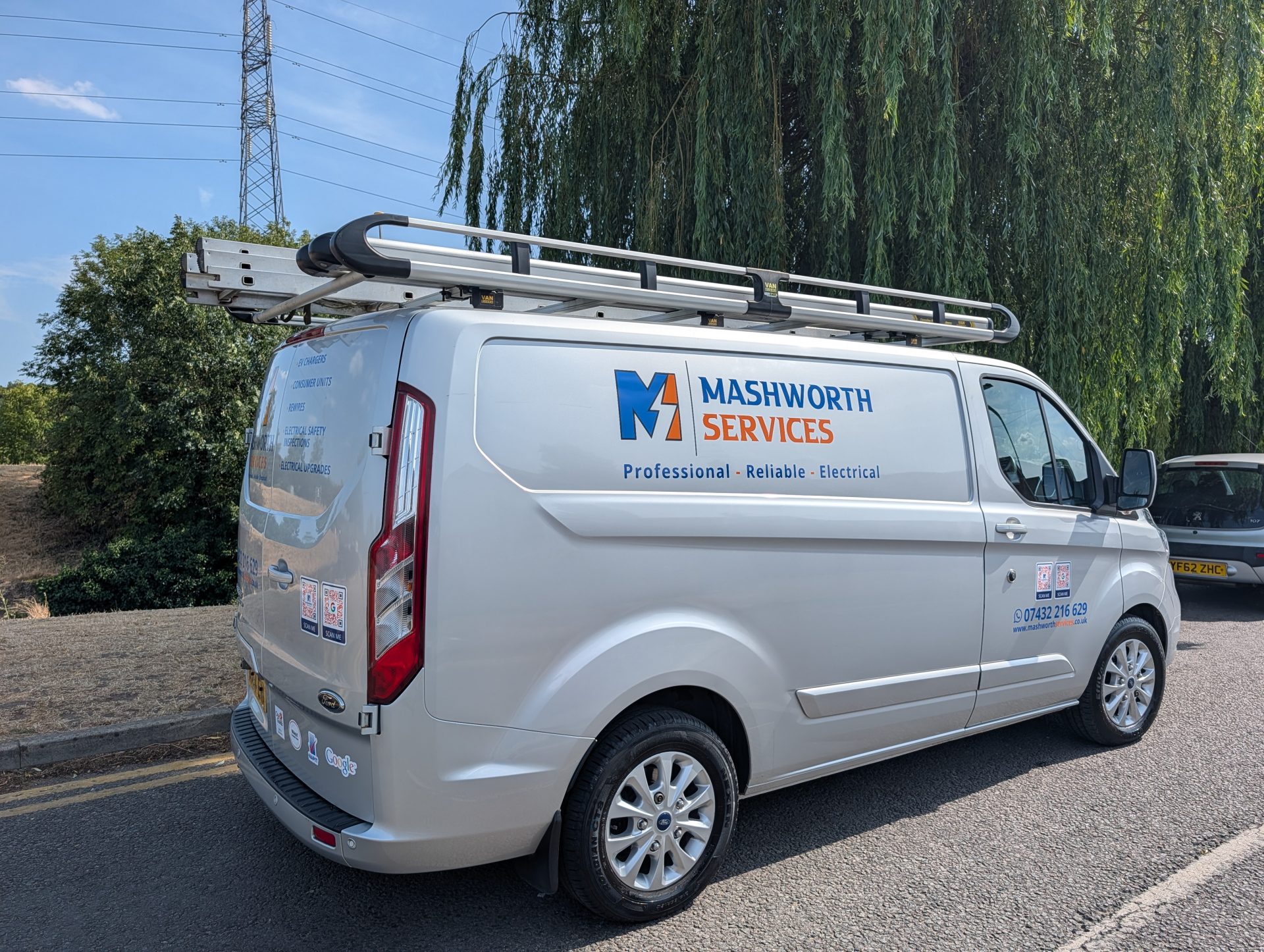 Side view of Mashworth Services electrical van with company logo and roof ladder rack