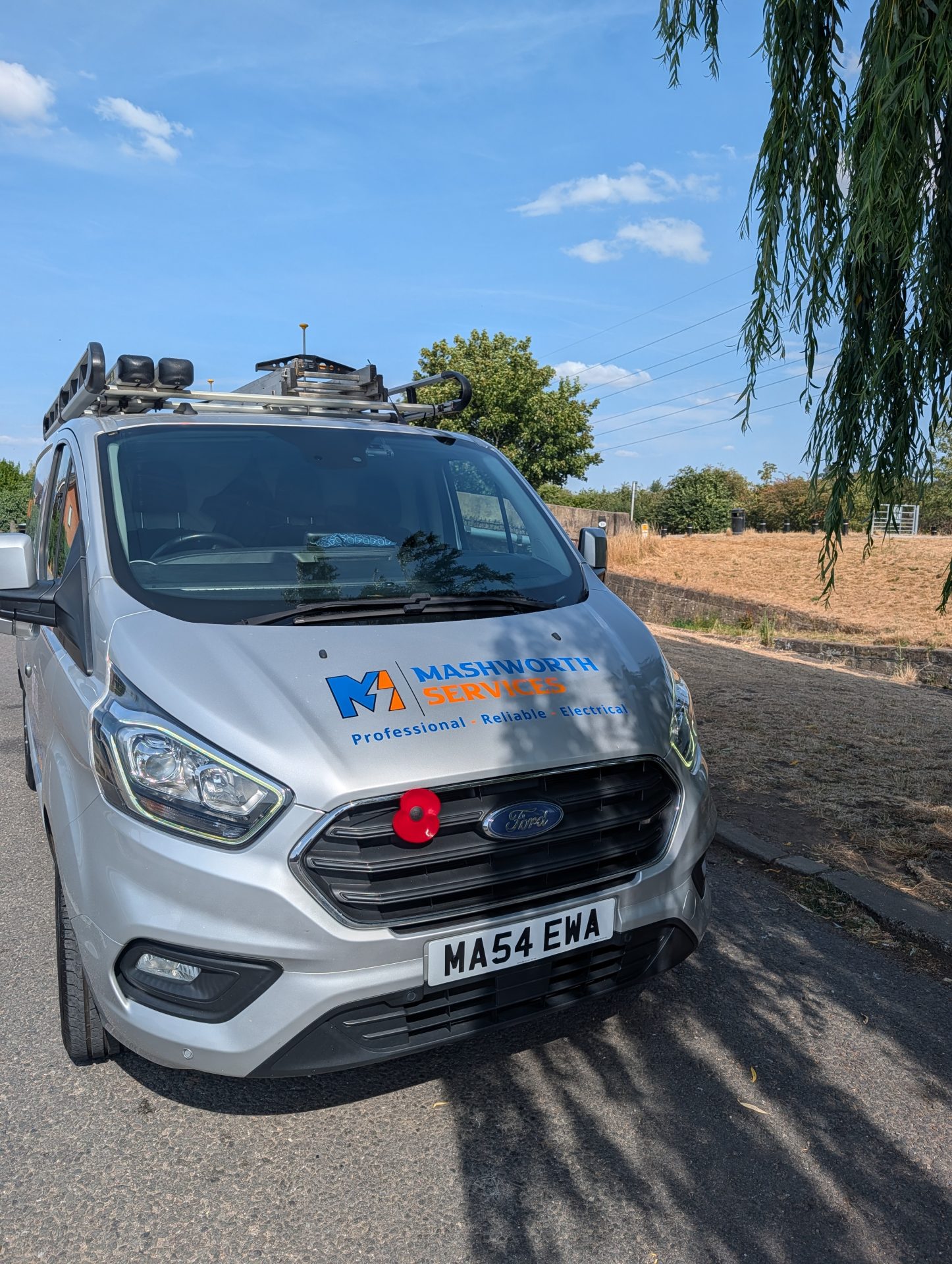 Mashworth Services work van photographed from the front on a sunny residential street